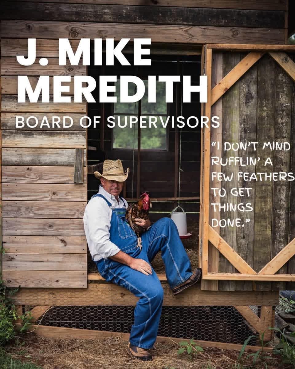 Campaign photo of J. Mike Meredith seated at a chicken coop in overalls and a straw hat, holding a rooster, with the quote: I don't mind rufflin' a few feathers to get things done.
